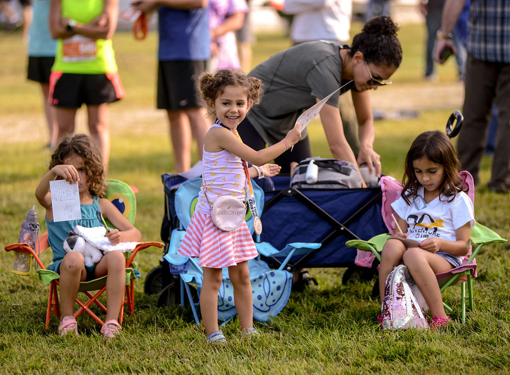Talia Padilla, 3, Miriam Padilla, 5, and Noa Padilla, 7, play, awaiting their father